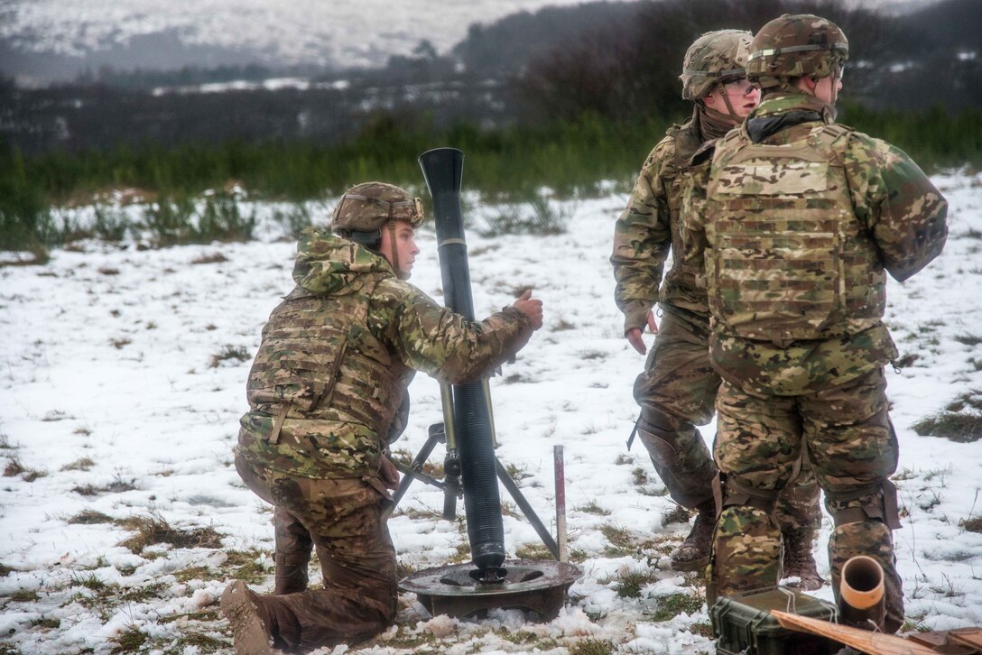 Soldiers receive follow-on orders before firing an M-252A1 81mm mortar system.