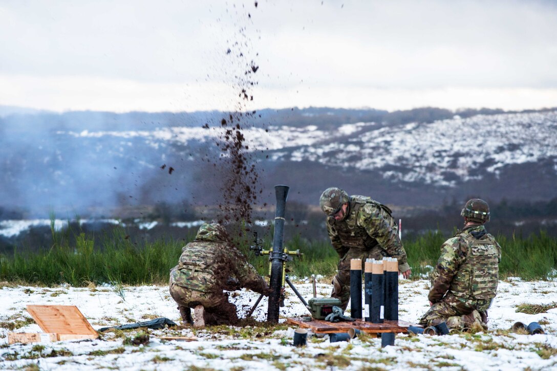 Soldiers fire an M-252A1 81mm mortar system.