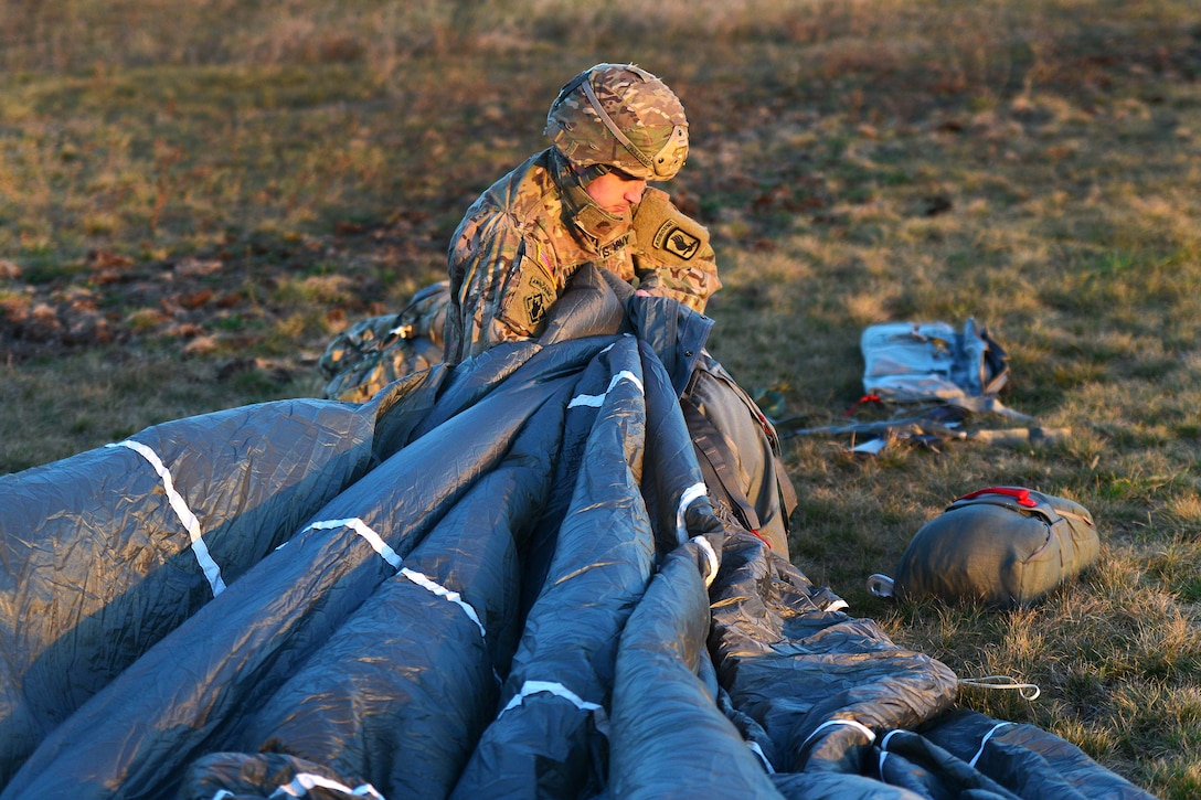 A soldier recovers his parachute and equipment during an airborne operation.