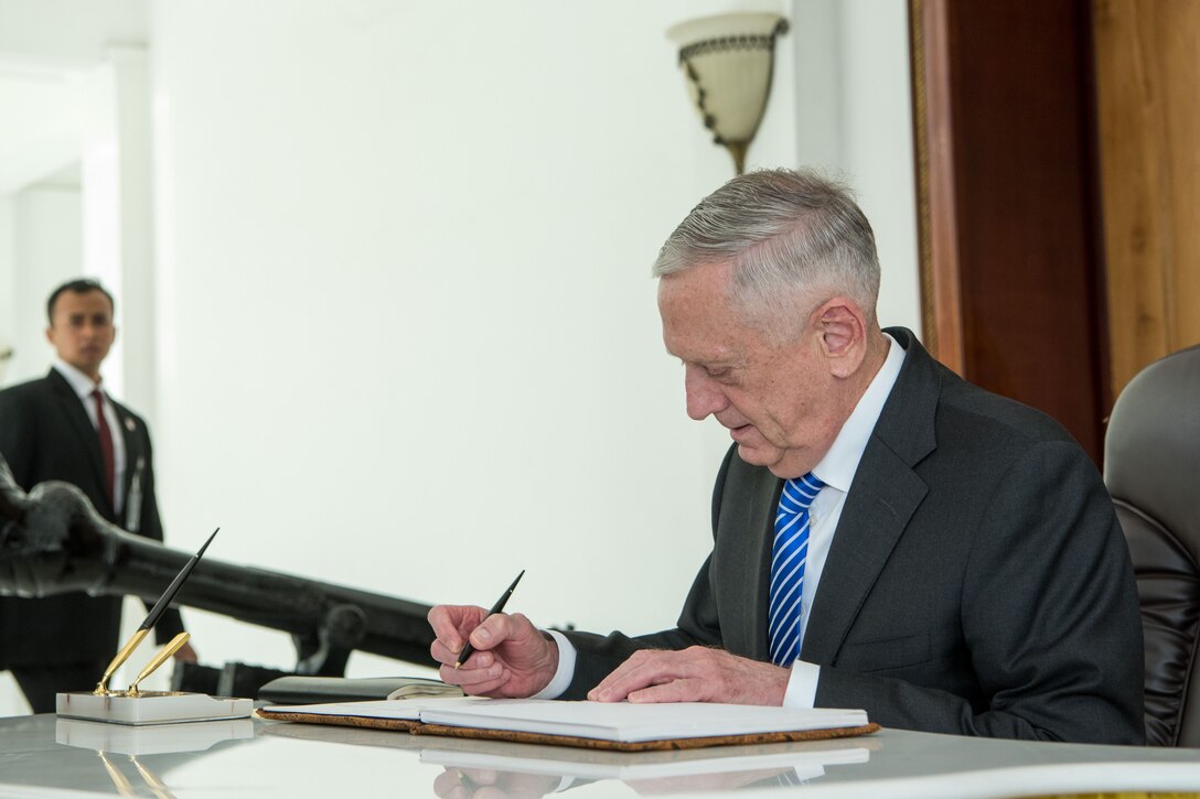 Defense Secretary James N. Mattis signs the guestbook at the Indonesian Defense Ministry in Jakarta.