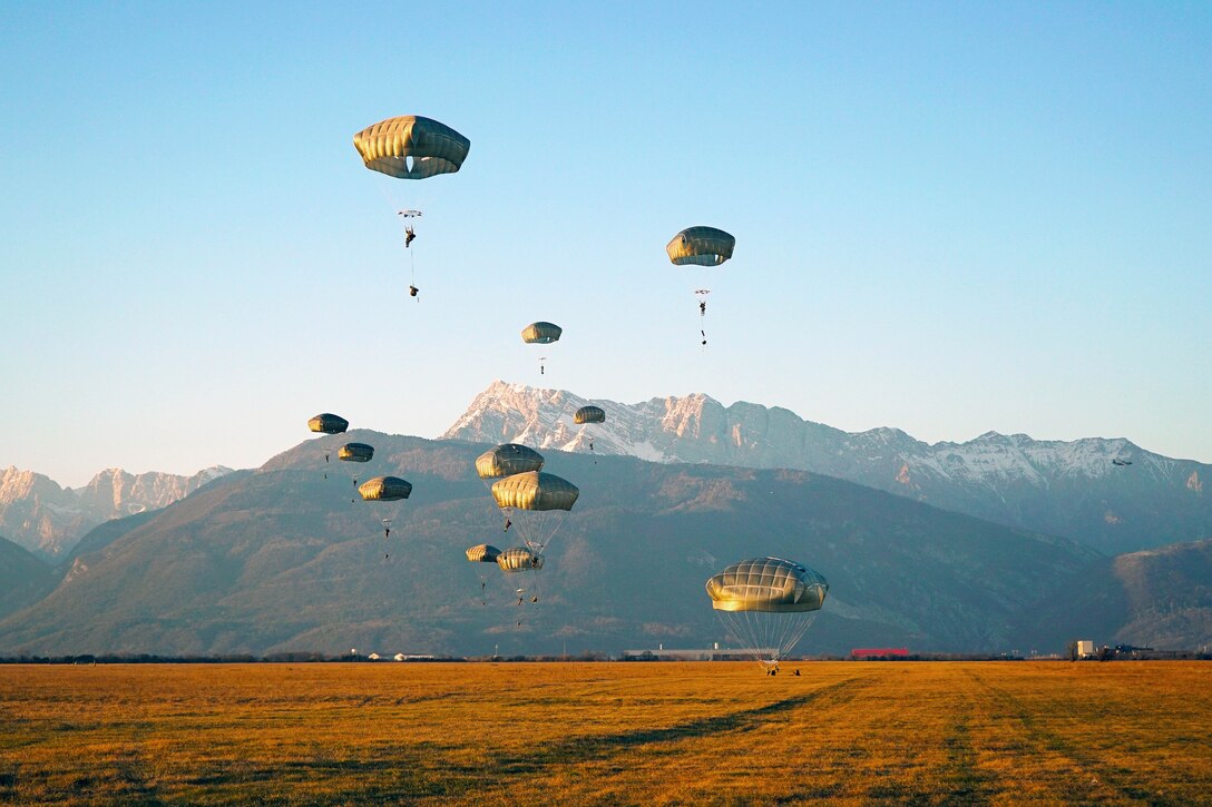Soldiers descend in front of the Venetian Alps onto Juliet Drop Zone during airborne operations.