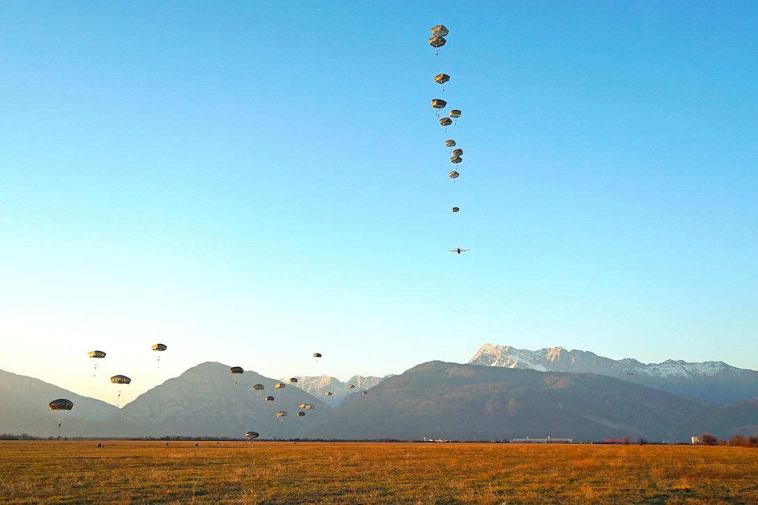 Soldiers descend in front of the Venetian Alps onto Juliet Drop Zone during airborne operations in Pordenone, Italy.