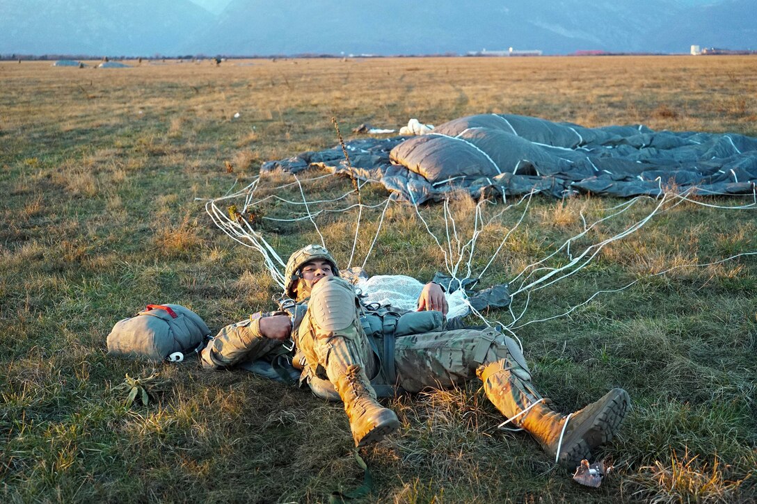 An airborne soldier recovers after landing at Juliet Drop Zone in Pordenone, Italy.
