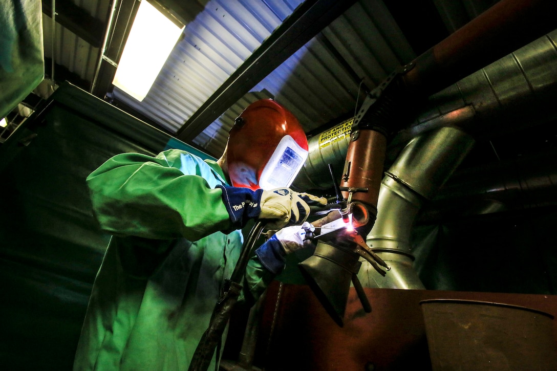 North Carolina Army National Guard Sgt. Michael Gray welds stainless steel.