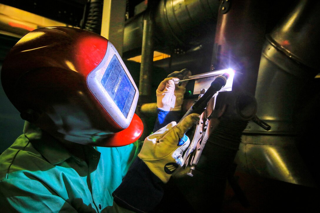 North Carolina Army National Guard Sgt. Michael Gray performs gas tungsten arc welding.