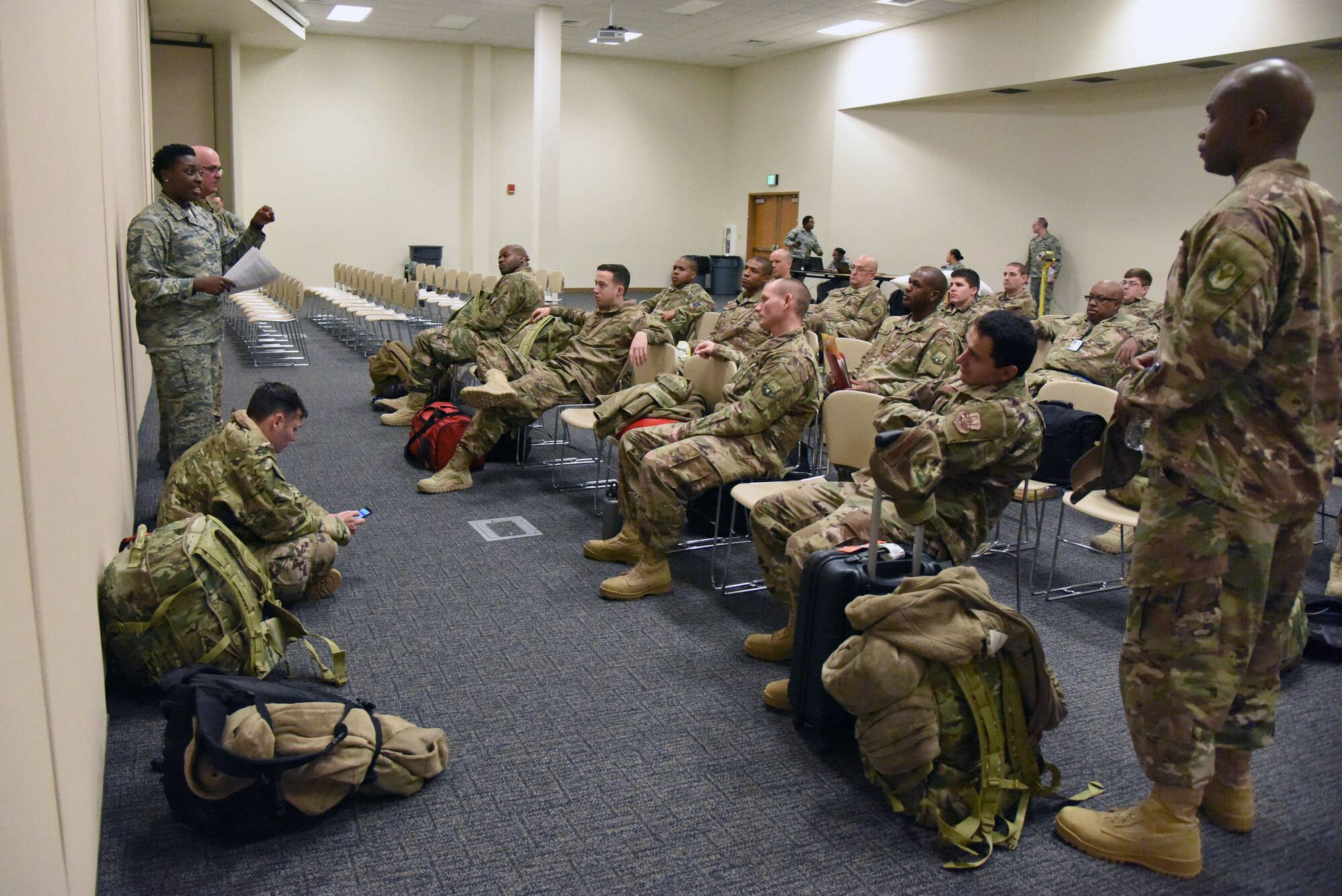 Tech. Sgt. Sabrina Martin, 81st Logistics Readiness Squadron personal property passenger travel NCO in charge, briefs on anti- hijacking safety procedures to Keesler personnel as they in process for deployment at the Roberts Consolidated Aircraft Maintenance Facility Jan. 8, 2018, on Keesler Air Force Base, Mississippi. Members of the 403rd Wing make preparations for an upcoming deployment to an undisclosed location. (U.S. Air Force photo by Kemberly Groue)