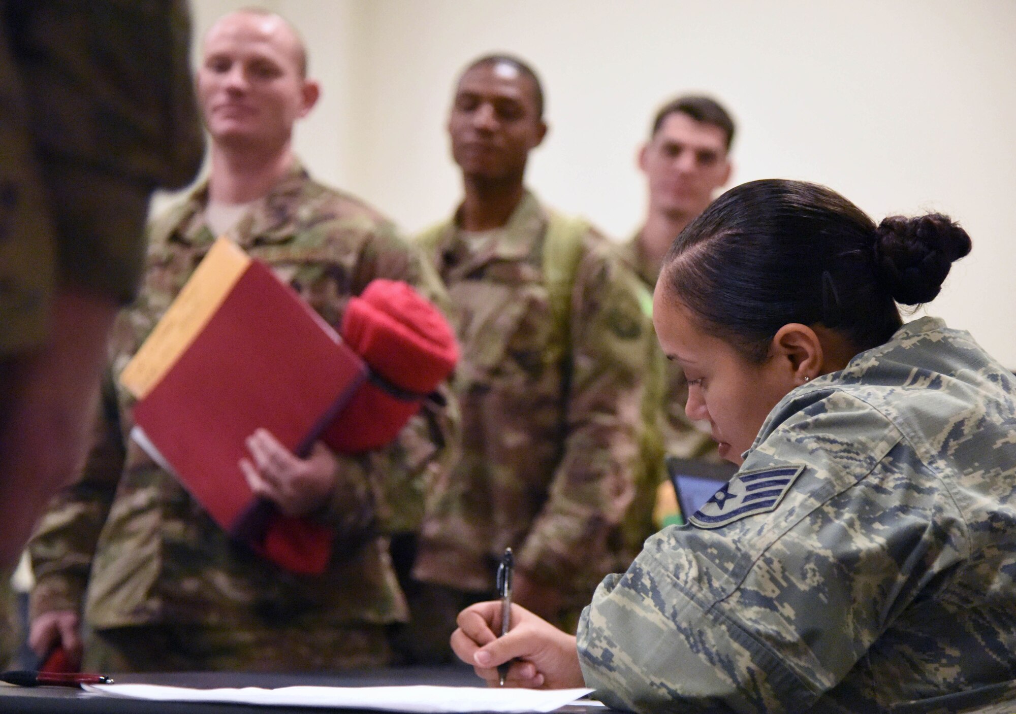 Staff Sgt. Carolmesha Stewart, 81st Logistics Readiness Squadron passenger travel processor, in-processes Keesler personnel for deployment at the Roberts Consolidated Aircraft Maintenance Facility Jan. 8, 2018, on Keesler Air Force Base, Mississippi. Members of the 403rd Wing make preparations for an upcoming deployment to an undisclosed location. (U.S. Air Force photo by Kemberly Groue)