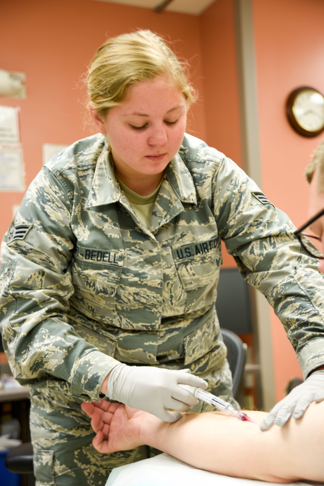 Senior Airman Kaydra Hart-Bedell inserts an IV on a patient at the Tripler Army Medical Center emergency room Jan. 17, 2018, Honolulu, HI.