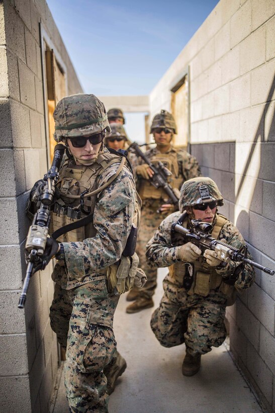 Marines clear hallways during explosives breach training.