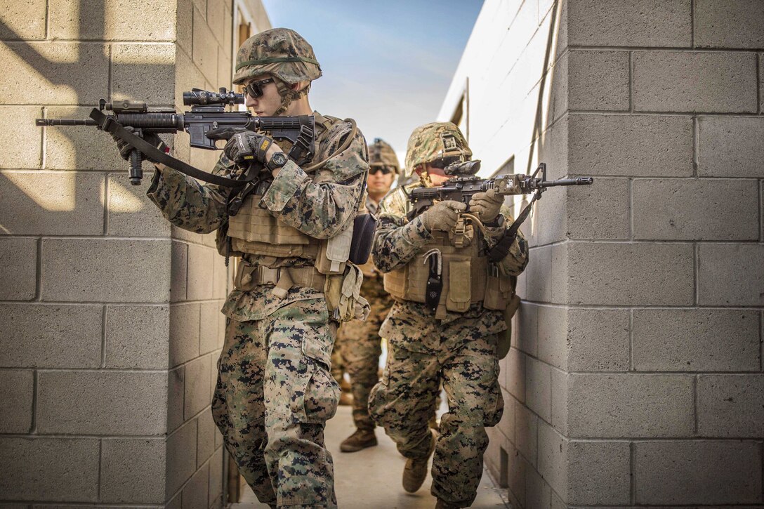 Marines clear hallways and provide security during explosives breach training.