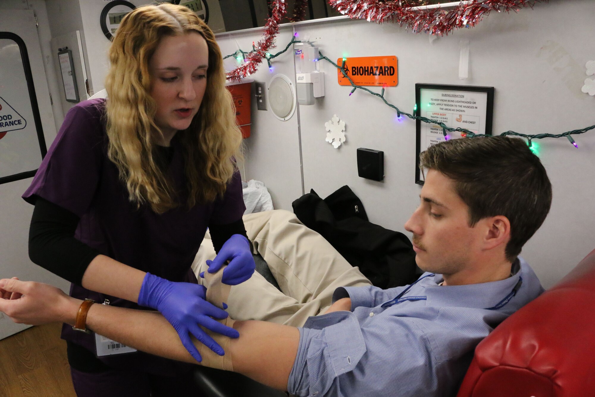 Blood Assurance technician Lauren Phillips bandages Daniel Ogg, a research mechanical engineer with the High Speed Systems Division of the Air Force Research Laboratory at Arnold Air Force Base, following a recent blood donation. Blood drives across Arnold AFB are set to increase in 2018. (U.S. Air Force photo/Brad Hicks)