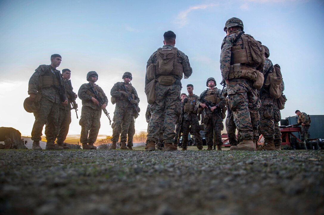 Marines conduct an after action review following urban explosives breach training.