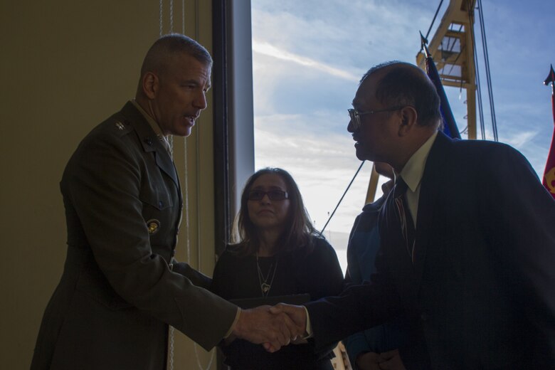 Major General William F. Mullen III, Commanding General, Marine Air Ground Task Force Training Command, Marine Corps Air Ground Combat Center, shakes hands with Staff Sgt. Enrico Antonio Rojo's family at a memorial aboard the Marine Corps Air Ground Combat Center, Twentynine Palms, Calif., Jan. 21, 2018. He served in the Marine Corps Reserve from 2009-2016. Staff Sgt. Rojo was awarded a Navy and Marine Corps Medal for attempting to help the victim of a car accident on December 16, 2016. (U.S. Marine Corps photo by Pfc. Rachel K. Porter).