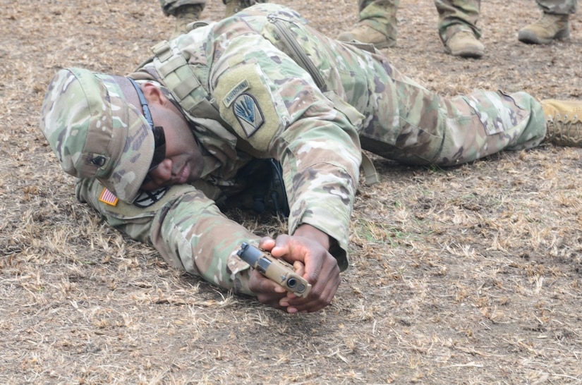 rmy Staff Sgt. Curtis Graham demonstrates how to properly shoot the new XM17 pistol from the prone position at the Joint Readiness Training Center at Fort Polk, La.