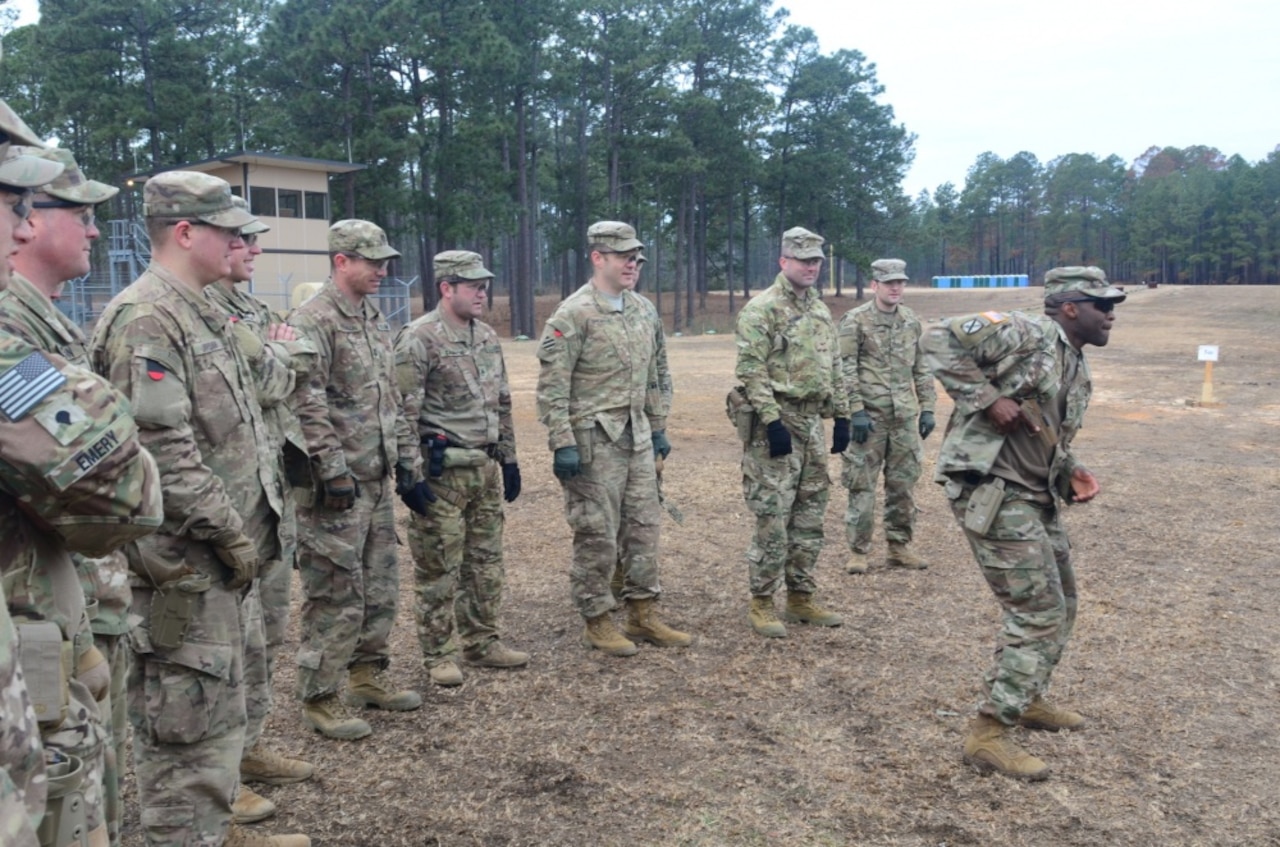 Army Staff Sgt. Curtis Graham shows 1st Security Force Assistance Brigade soldiers how to shoot the new XM17 pistol during a demonstration at the Joint Readiness Training Center at Fort Polk, La.