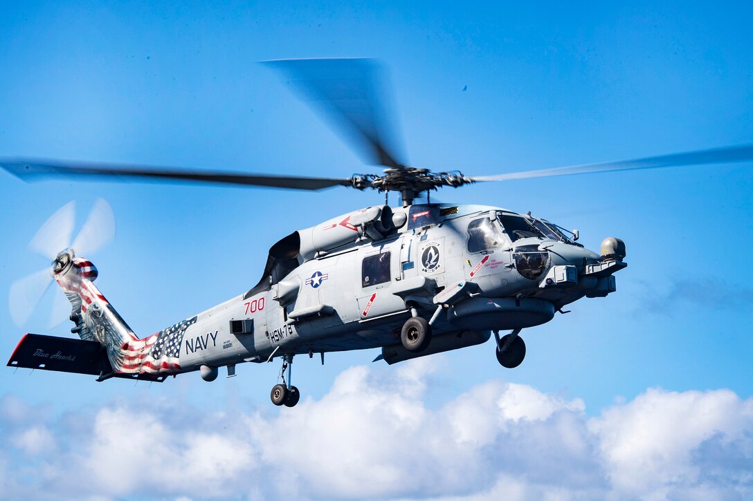An MH-60R Sea Hawk helicopter prepares to land.