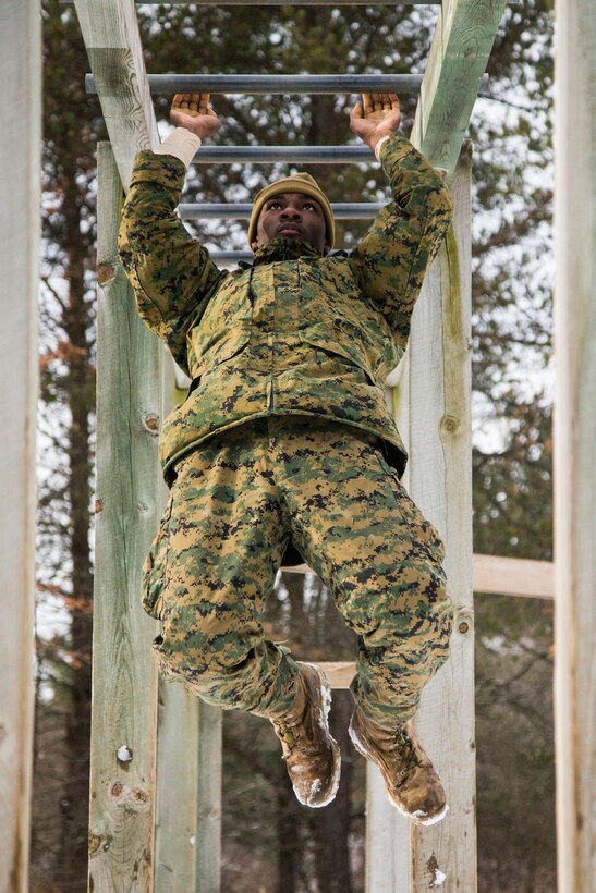 A Marine hands on a bar.