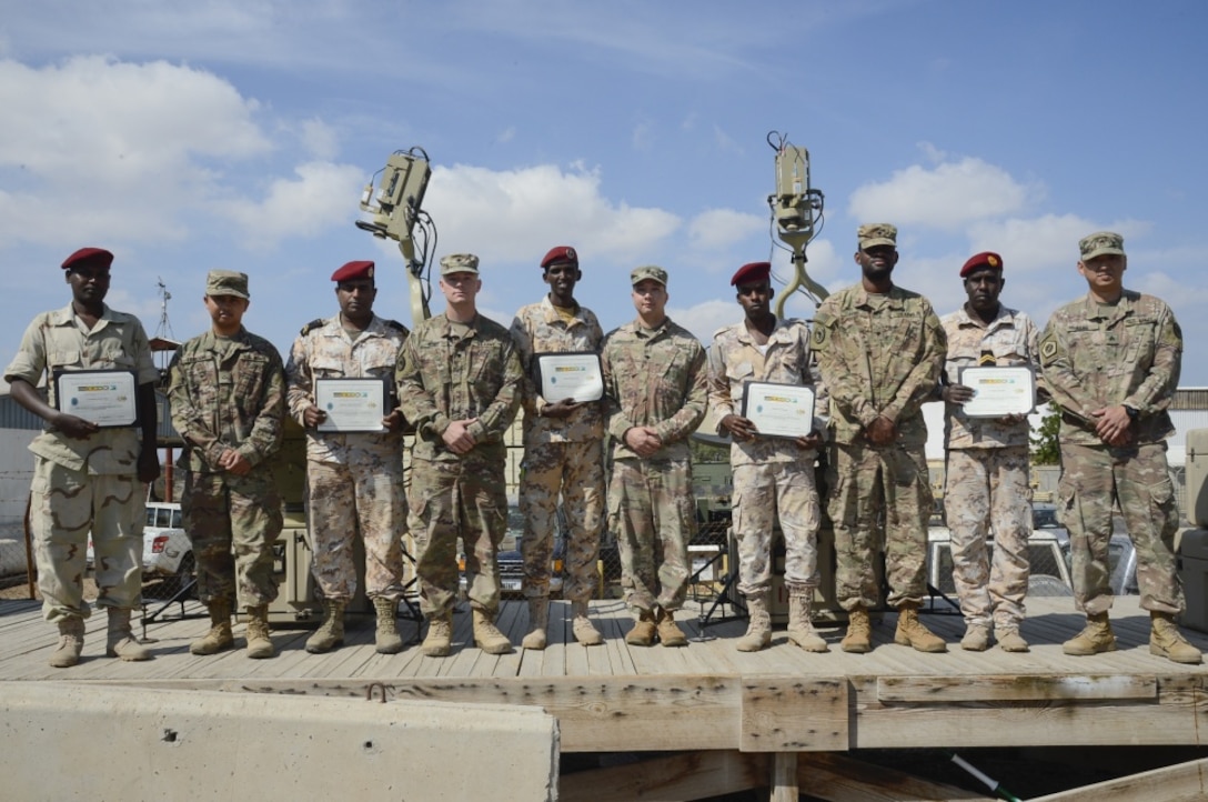 Soldiers assigned to Combined Joint Task Force-Horn of Africa’s communications directorate and Djiboutian service members pose for a photo after completing a military-to-military exchange course at Camp Lemonnier, Djibouti.