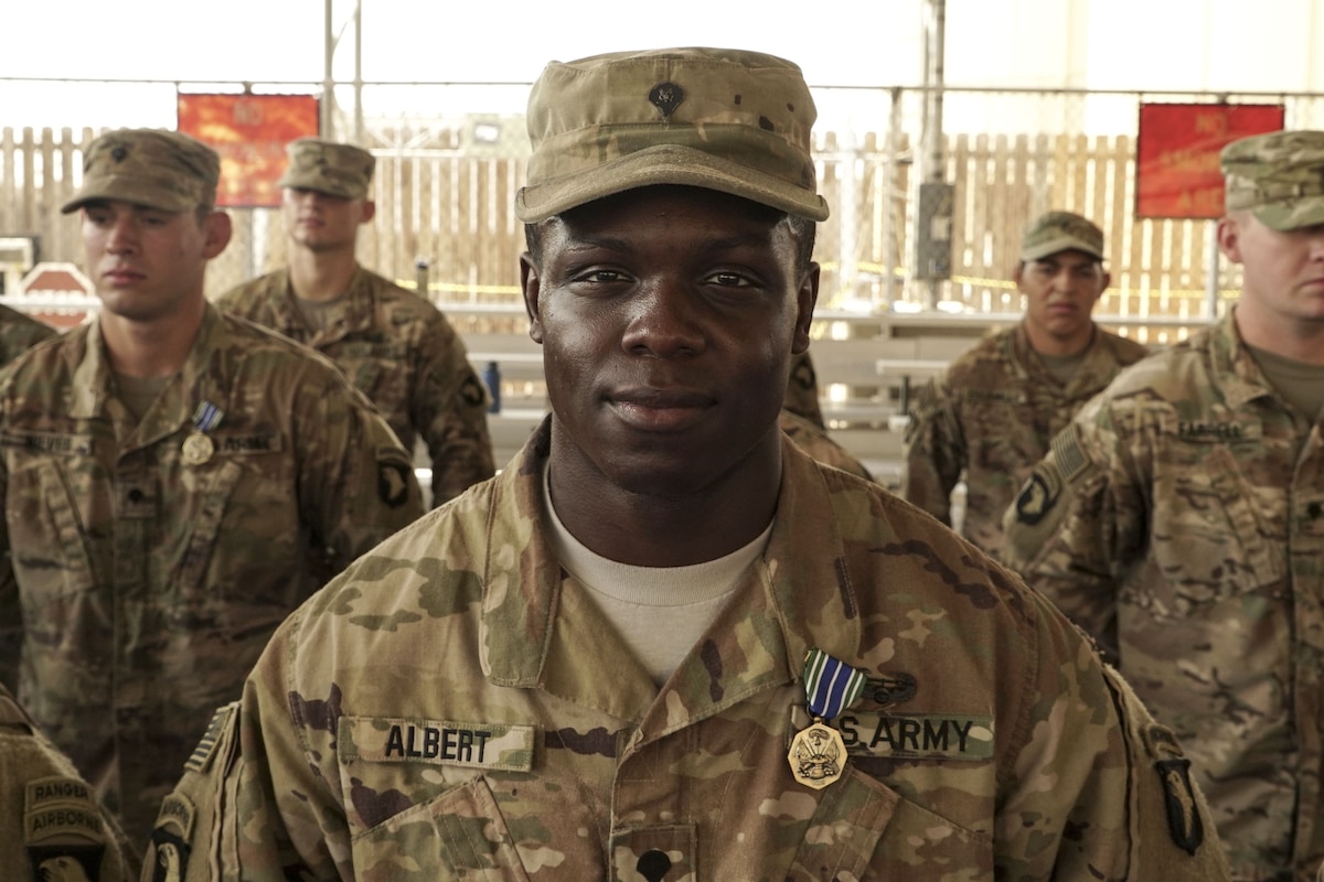 A soldier looks strait forward while in formation.