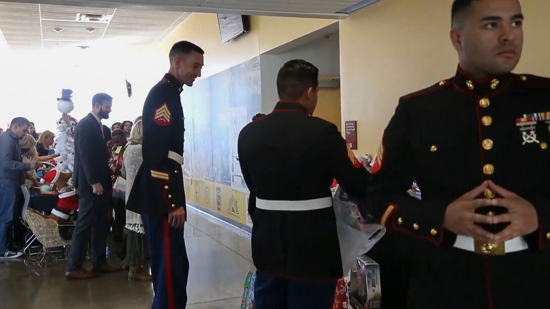 U.S. Marines assigned to Marine Fighter Training Squadron (VMFT) 401 offer helping hands to the Toys for Tots event at the Arizona Western College Conference Center, Dec. 18, 2017. Toys for Tots was founded by U.S. Marine Corps Reservist Maj. William L. Hendricks in 1947 and in 1991, the Secretary of Defense, Dick Cheney, made Toys for Tots an official mission of the Marine Corps Reserves. (U.S. Marine Corps video screenshot by Lance Cpl. Eric Q. Shannon)