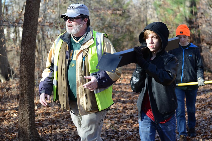 Dr. Christopher McDaid, 733rd CED Environmental Element archaeologist walks with Fort Eustis Boys Scouts Troop 45 members to install educational environmental signs along the nature trail, located on Monroe Avenue behind the Jacobs Conference Center at Joint Base Langley-Eustis, Va., Jan. 20, 2018.