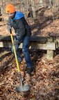 Nicholas Burney, left, age 13, Fort Eustis Boys Scouts Troop 45 member and son of U.S. Army Master Sgt. Nicholas Burney, 1st Battalion, 210th Aviation Regiment, 128th Aviation Brigade NCO and Fort Eustis Troop 45 scout master, digs a hole for an educational environmental sign along the nature trail at Joint Base Langley-Eustis, Va., Jan. 20, 2018.