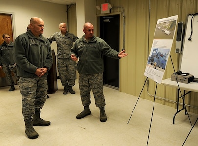 U.S. Air Force Tech. Sgt. Robert Russell, right, 628th Civil Engineer Squadron, Non-Commissioned Officer in Charge of Logistics for Fire Emergency Services, briefs U.S. Air Force General Carlton D. Everhart, commander, Air Mobility Command, Scott Air Force Base, Ill., on the shipboard firefighting program here, Jan.17, 2018. Everhart visited Mobility Airmen from various units at Joint Base Charleston to gain valuable insight of their mission successes along with the challenges they may face while executing rapid global mobility.