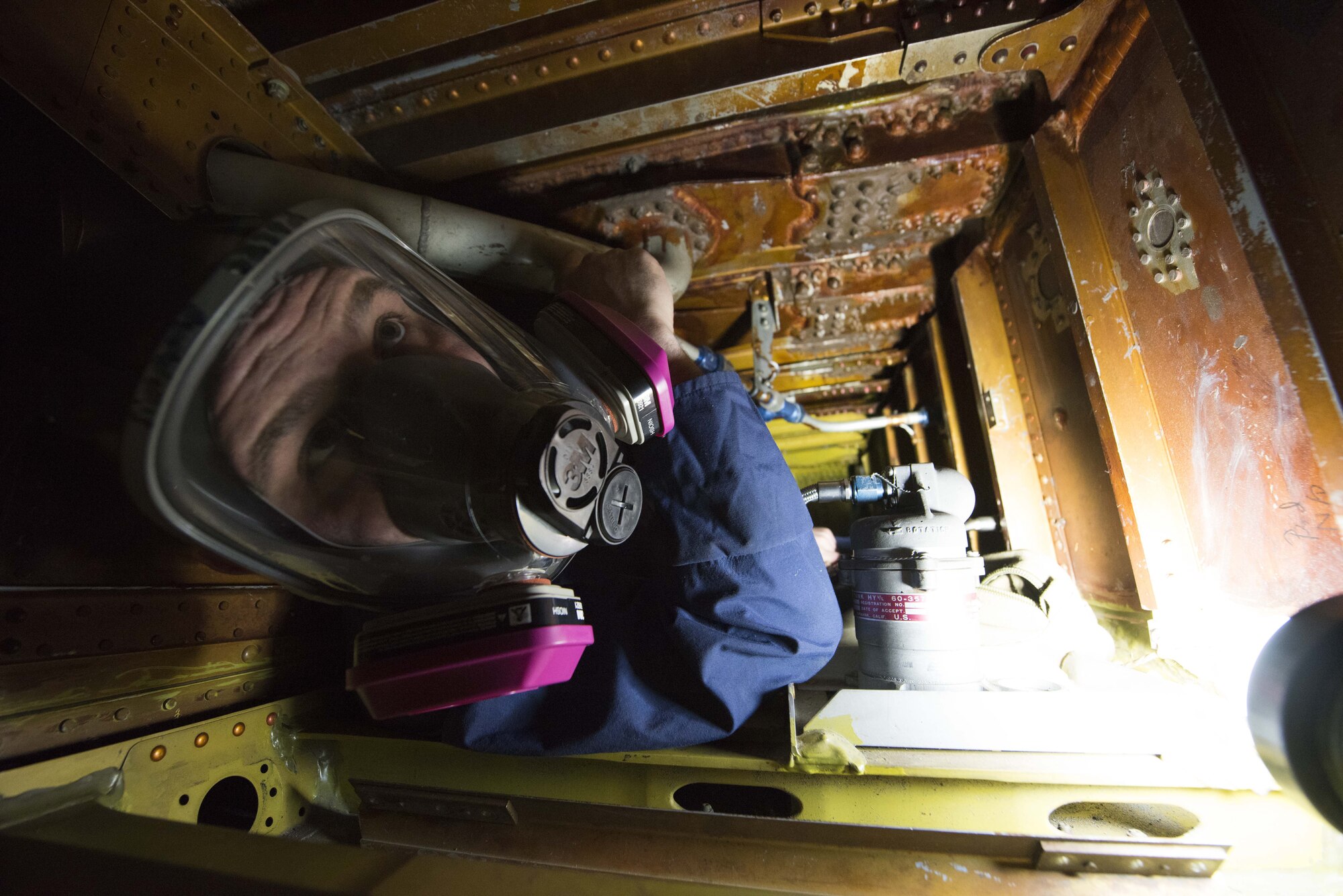 Airman 1st Class Elijah Simmons, 92nd Maintenance Squadron, Aircraft Fuel Systems Squadron apprentice, maneuvers into position inside the fuel tank training module, a section of a former KC-135 Stratotanker wing, during a training session at Fairchild Air Force Base, Washington, Nov. 21, 2017. The confines inside of a KC-135's wing can range from three by two and a half feet, to only 18 inches high and wide. (U.S. Air Force photo/Senior Airman Ryan Lackey)