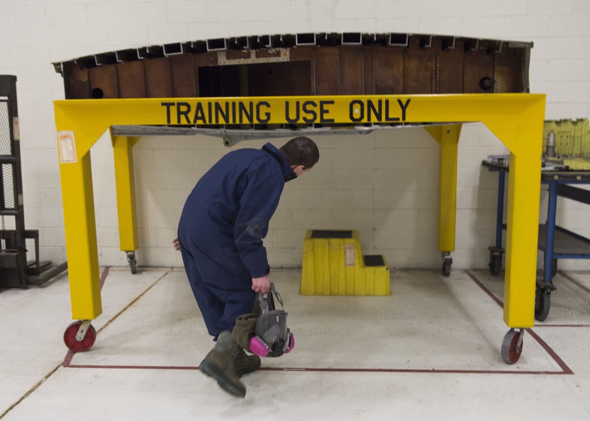 Airman 1st Class Elijah Simmons, 92nd Maintenance Squadron, Aircraft Fuel Systems Squadron apprentice, prepares to enter a fuel tank training module, a section of a former KC-135 Stratotanker wing, during a training session at Fairchild Air Force Base, Washington, Nov. 21, 2017. Fuel leaks on an aircraft can be a disaster mid-air or prevent an aircraft from possessing enough fuel pressure to even take off, making it a critical part of maintenance. (U.S. Air Force photo/Senior Airman Ryan Lackey)
