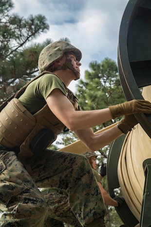 Lance Cpl. Nathaniel Warnsley, Bulk Fuel Specialist, Bulk Fuel Company, 8th Engineer Support Battalion, 2nd Marine Logistics Group, assists in the assembly of a Tactical Fuel System during a training exercise aboard Camp Lejeune, N.C., Jan. 12, 2018. The exercise was designed to increase proficiency while sustaining ground readiness and combat capability of II Marine Expeditionary Force. (U.S. Marine Corps photo by Lance Cpl. Tyler W. Stewart)