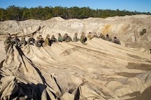 Marines with Bulk Fuel Company, 8th Engineer Support Battalion, 2nd Marine Logistics Group, deconstruct a Tactical Fuel System during a training exercise at Engineer Training Area 2 aboard Camp Lejeune, N.C., Jan. 12, 2018. The exercise was designed to increase proficiency while sustaining ground readiness and combat capability of II Marine Expeditionary Force. (U.S. Marine Corps photo by Lance Cpl. Tyler W. Stewart)