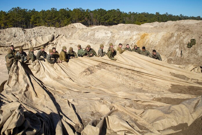 Marines with Bulk Fuel Company, 8th Engineer Support Battalion, 2nd Marine Logistics Group, deconstruct a Tactical Fuel System during a training exercise at Engineer Training Area 2 aboard Camp Lejeune, N.C., Jan. 12, 2018. The exercise was designed to increase proficiency while sustaining ground readiness and combat capability of II Marine Expeditionary Force. (U.S. Marine Corps photo by Lance Cpl. Tyler W. Stewart)