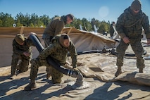 Marines with Bulk Fuel Company, 8th Engineer Support Battalion, 2nd Marine Logistics Group, deconstruct a Tactical Fuel System during a training exercise at Engineer Training Area 2 aboard Camp Lejeune, N.C., Jan. 12, 2018. The exercise was designed to increase proficiency while sustaining ground readiness and combat capability of II Marine Expeditionary Force. (U.S. Marine Corps photo by Lance Cpl. Tyler W. Stewart)