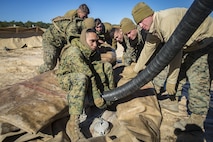 Marines with Bulk Fuel Company, 8th Engineer Support Battalion, 2nd Marine Logistics Group, deconstruct a Tactical Fuel System during a training exercise at Engineer Training Area 2 aboard Camp Lejeune, N.C., Jan. 12, 2018. The exercise was designed to increase proficiency while sustaining ground readiness and combat capability of II Marine Expeditionary Force. (U.S. Marine Corps photo by Lance Cpl. Tyler W. Stewart)