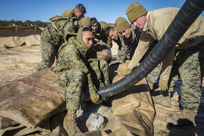 Marines with Bulk Fuel Company, 8th Engineer Support Battalion, 2nd Marine Logistics Group, deconstruct a Tactical Fuel System during a training exercise at Engineer Training Area 2 aboard Camp Lejeune, N.C., Jan. 12, 2018. The exercise was designed to increase proficiency while sustaining ground readiness and combat capability of II Marine Expeditionary Force. (U.S. Marine Corps photo by Lance Cpl. Tyler W. Stewart)