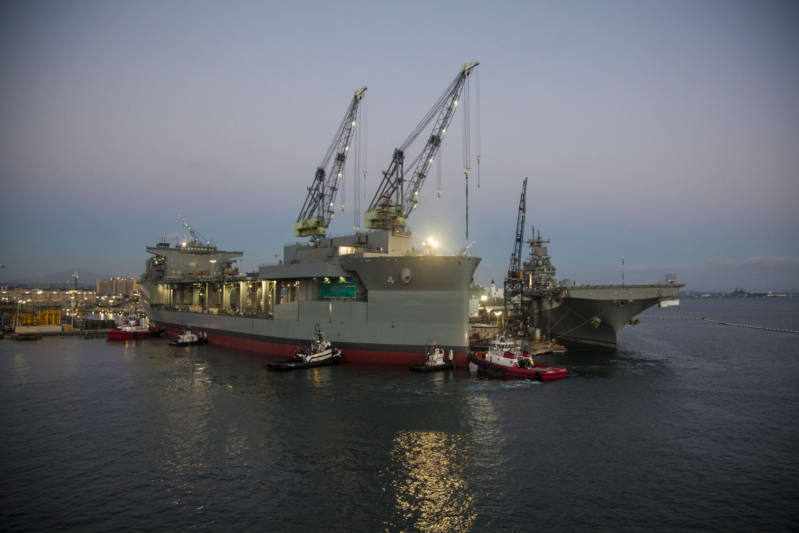 USNS Hershel ‘Woody’ Williams (ESB 4) is preparing to be floated out and launched at the General Dynamics NASSCO shipyard, Aug. 19. In the background, USS Boxer (LHD 4) is undergoing maintenance and modernization. (Courtesy photo by General Dynamics NASSCO)