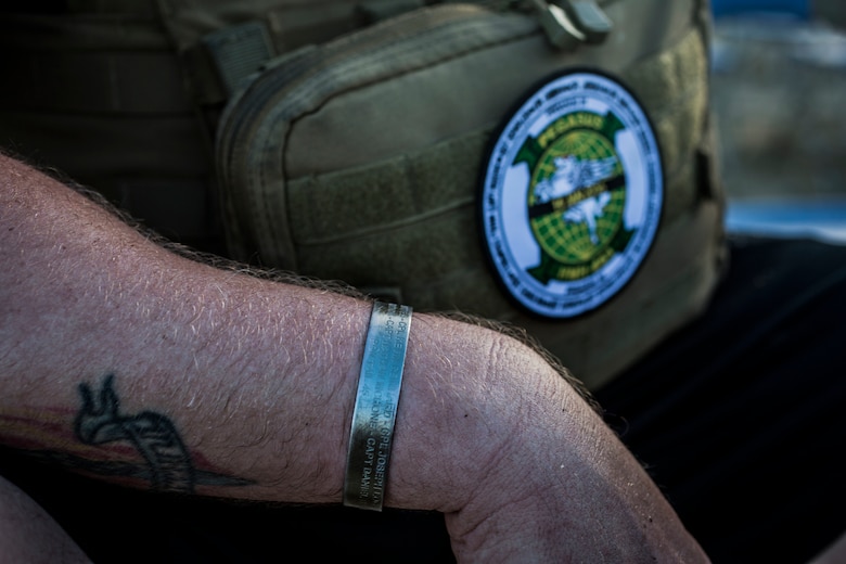 Gunnery Sgt. Matthew Forsstrom, a flightline division chief with Marine Heavy Helicopter Squadron 463 (HMH-463), displays his memorial bracelet and unit patch upon completion of the squadron’s memorial hike, Marine Corps Base Hawaii, Jan. 11, 2018. The hike commemorated the 12 Marines from the squadron who were lost in a CH-53E crash while conducting training operations in 2016. While the hike was a solemn reminder of those the squadron lost, it also served as an event to help celebrate the Marines’ lives and the proud traditions of HMH-463. (U.S. Marine Corps Photo by Lance Cpl. Luke Kuennen)