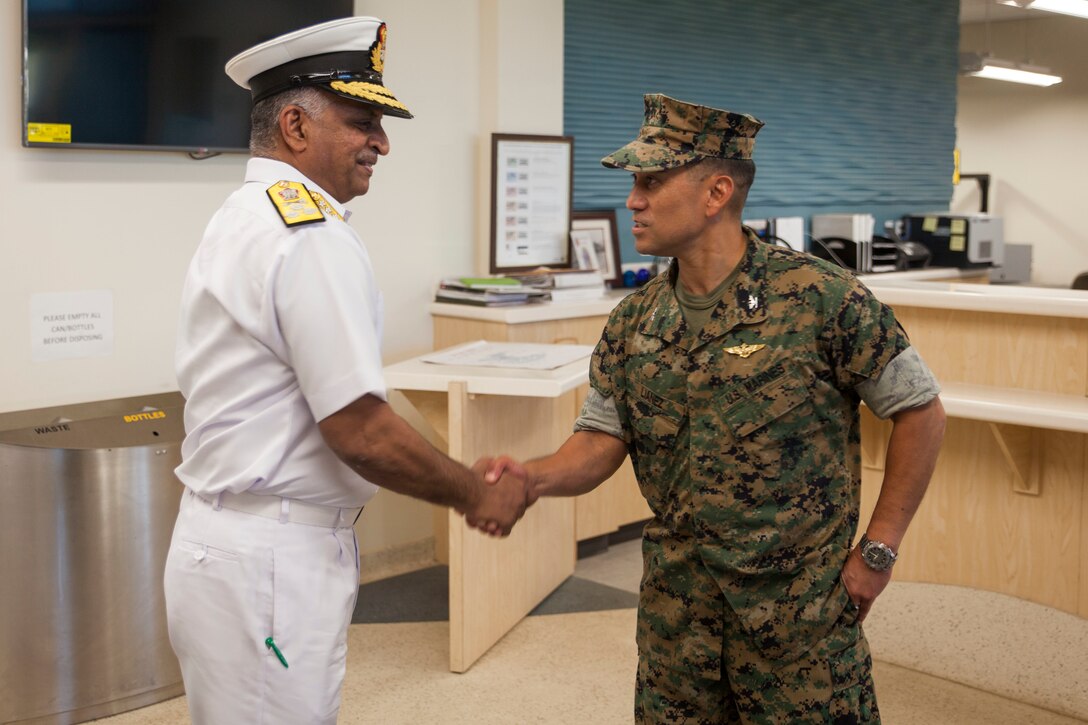 Vice Adm. G. Ashok Kumar, the Deputy Chief of Navy Staff for the Indian Navy, shakes hands wiith Col. Raul Lianez, the commanding officer of Marine Corps Base Hawai (MCBH), during a visit to the installation, MCBH, Jan. 18, 2018. Staff with Marine Corps Air Station Kaneohe Bay provided a historical guided tour for foreign delegates with the Indian Navy. The visit emphasized the long history of the air station, answered questions and helped to foster positive relations with foreign military forces. (U.S. Marine Corps photo by Cpl. Jesus Sepulveda Torres)