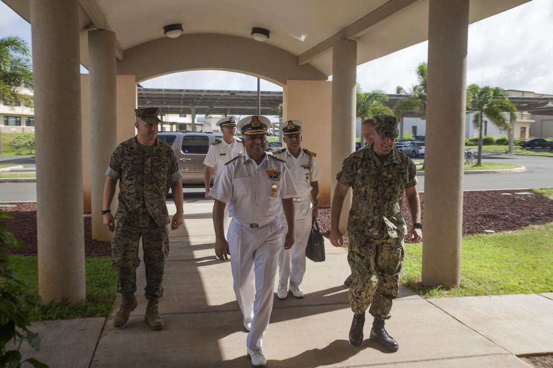 Vice Adm. G. Ashok Kumar, the Deputy Chief of Navy Staff for the Indian Navy, walks with Marine Corps Air Station (MCAS) Kaneohe Bay leadership during a base visit, Marine Corps Base Hawaii, Jan. 18, 2018. Staff with MCAS provided a historical guided tour for foreign delegates with the Indian Navy. The visit emphasized the long history of the air station, answered questions and helped to foster positive relations with foreign military forces. (U.S. Marine Corps photo by Cpl. Jesus Sepulveda Torres)