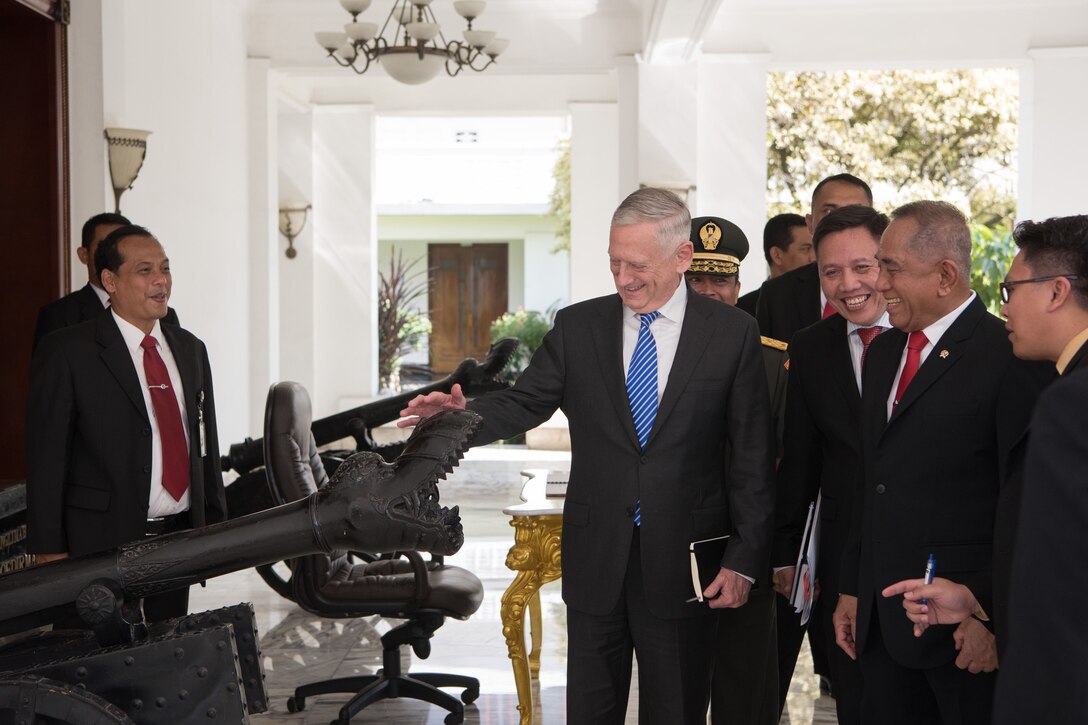 Defense Secretary Mattis examines an antique cannon at the Indonesian Defense Ministry.