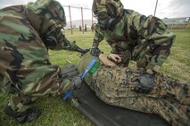 Marines with Combat Logistics Regiment 35 simulate victim decontamination of Lance Cpl. Isaac Jordan, a machinist with Maintenance Battalion, during decontamination training on Camp Kinser, Okinawa Jan. 23, 2018. This training is held by CLR 35 to reinforce how to effectively help casualties in of a chemical, biological, radioactive or nuclear attack. (Marine Corps photo taken by Pfc. Jamin M. Powell)