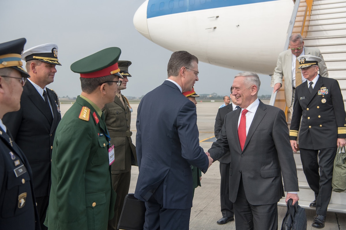 Defense Secretary James N. Mattis shakes hands with U.S officials after getting off a plane.