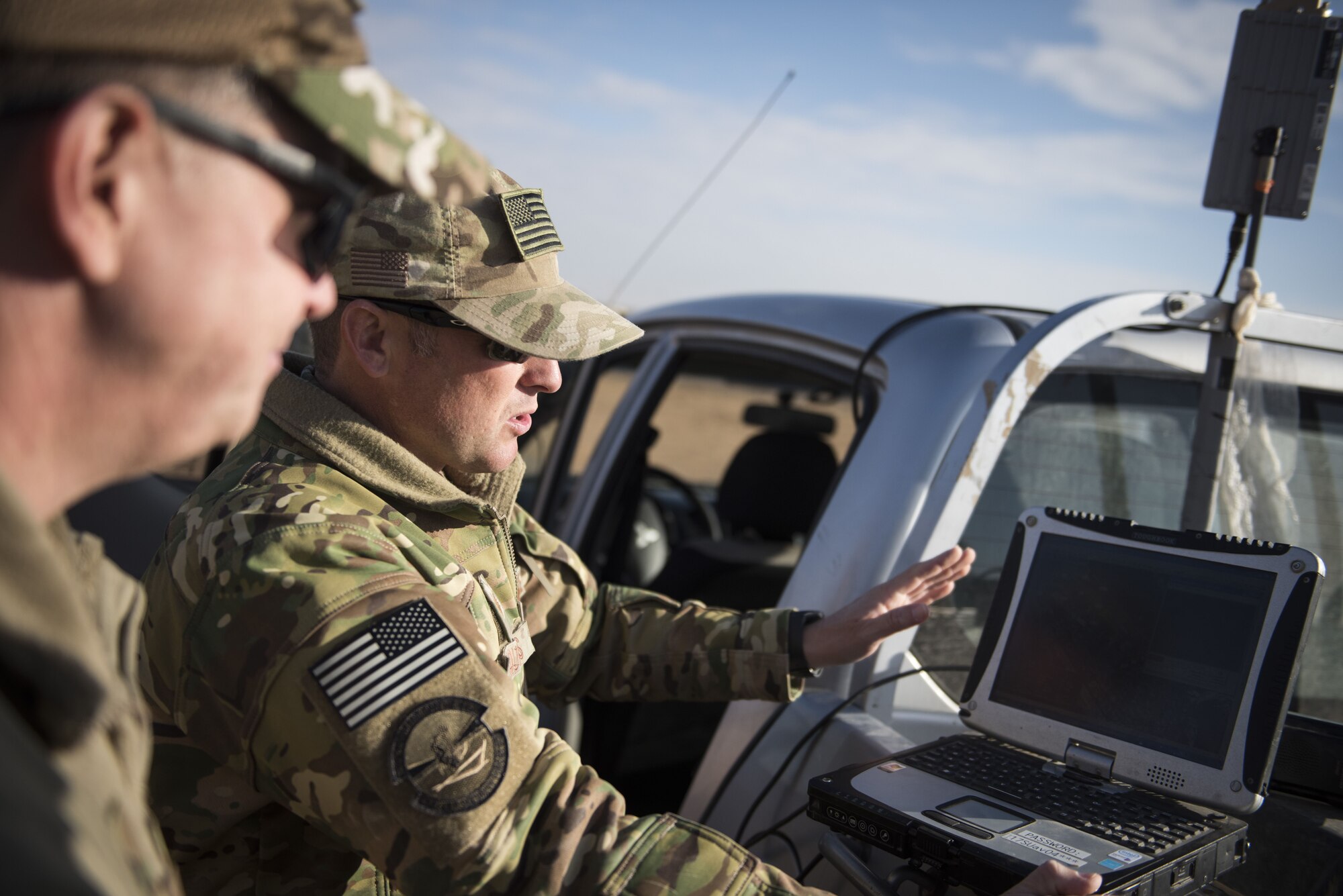 Tech Sgt. Matthew Coutts, assigned to the 332d Expeditionary Security Forces Squadron, demonstrates the capabilities of the Raven B Digital Data Link drone for Brig. Gen. Kyle Robinson, 332d Air Expeditionary Wing commander, Jan. 24, 2018 in Southwest Asia. The 332d ESFS uses the Raven B to monitor activity on the installation perimeter. (U.S. Air Force photo by Staff Sgt. Joshua Kleinholz)