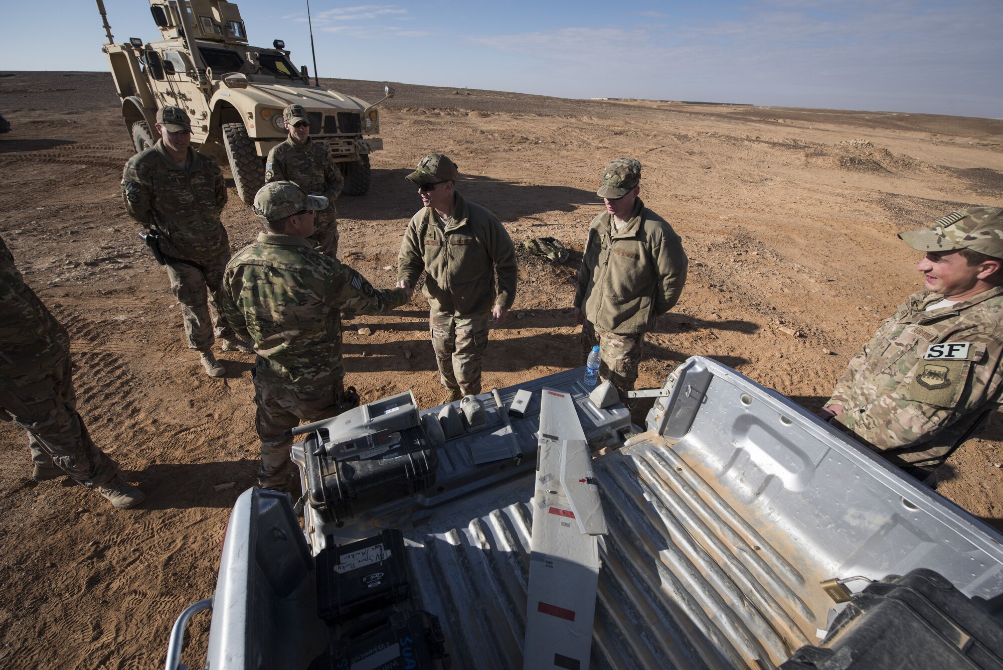 Brig. Gen. Kyle Robinson, 332d Air Expeditionary Wing commander, thanks members of the 332d Expeditionary Security Forces Squadron following a successful demonstration of the Raven B Digital Data Link drone Jan. 24, 2018 in Southwest Asia. Using the Raven B to monitor activity on the installation perimeter saves man hours, conserves fuel, and provides the ability to quickly respond to the unmanned aerial systems threat. (U.S. Air Force photo by Staff Sgt. Joshua Kleinholz)