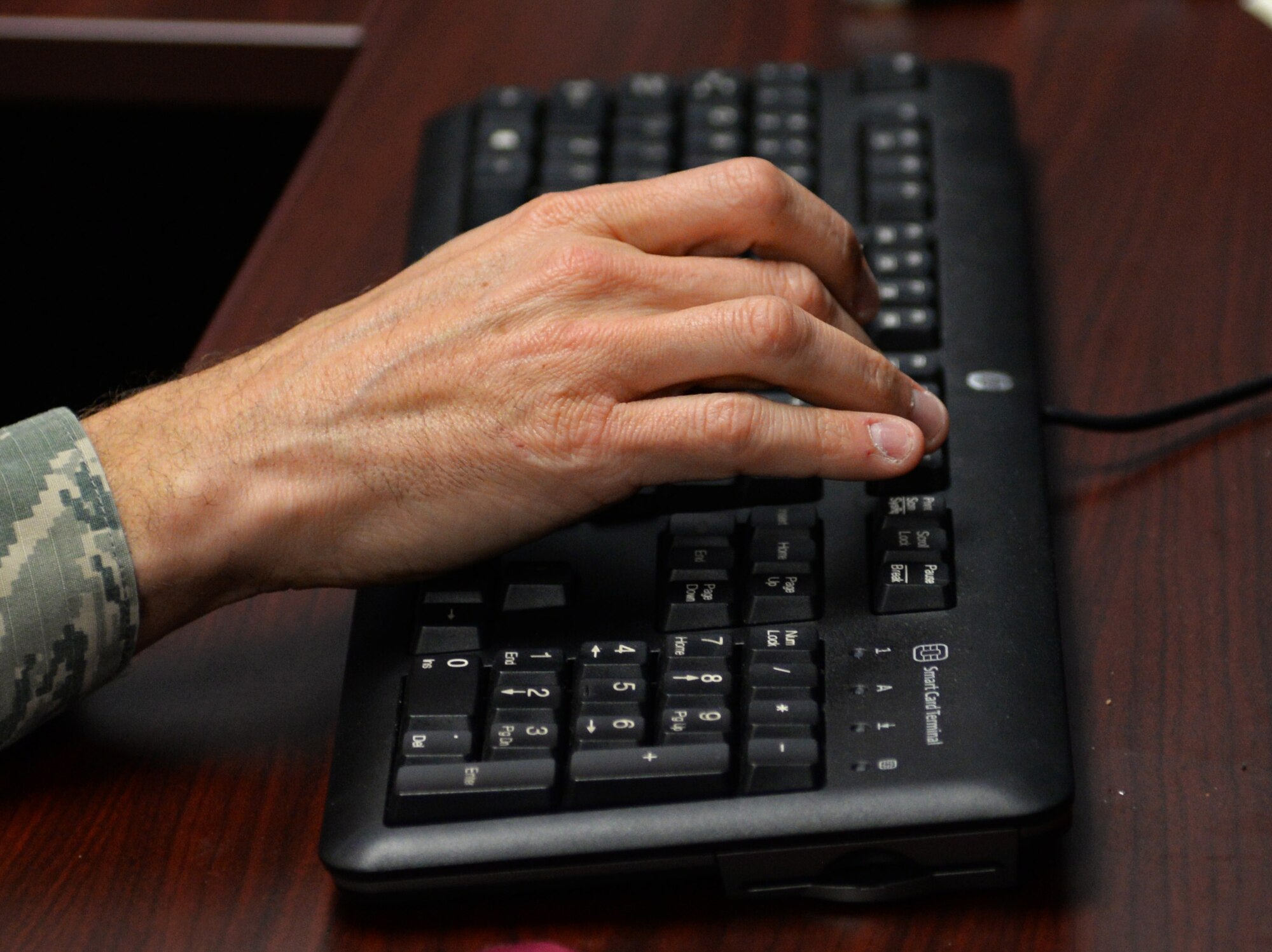 A 20th Fighter Wing Airman inputs codes to implement Windows 10 updates at Shaw Air Force Base, S.C., Jan. 22, 2018.