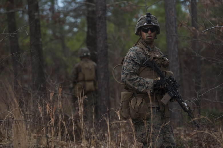 Lance Cpl. Branson Benavidez, a Marine with 2nd Battalion, 8th Marine Regiment, checks the rear of a patrol at a platoon live-fire range during a deployment for training exercise at Fort A.P. Hill, Va., Dec. 7, 2017. The Marines are conducting the training to maintain proficiency at the squad, platoon, company, and battalion-level of warfighting in preparation for an upcoming deployment to Japan. The Marines patrolled, detonated Bangalore torpedoes to breach obstacles, threw M67 fragmentation grenades to clear trenches, and conducted live-fire movements to take an objective. (U.S. Marine Corps photo by Lance Cpl. Ashley McLaughlin)