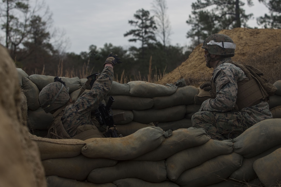 A Marine with 2nd Battalion, 8th Marine Regiment throws an M67 fragmentation grenade at a platoon live-fire range during a deployment for training exercise at Fort A.P. Hill, Va., Dec. 7, 2017. The Marines are conducting the training to maintain proficiency at the squad, platoon, company, and battalion-level of warfighting in preparation for an upcoming deployment to Japan. The Marines patrolled, detonated Bangalore torpedoes to breach obstacles, threw M67 fragmentation grenades to clear trenches, and conducted live-fire movements to take an objective. (U.S. Marine Corps photo by Lance Cpl. Ashley McLaughlin)