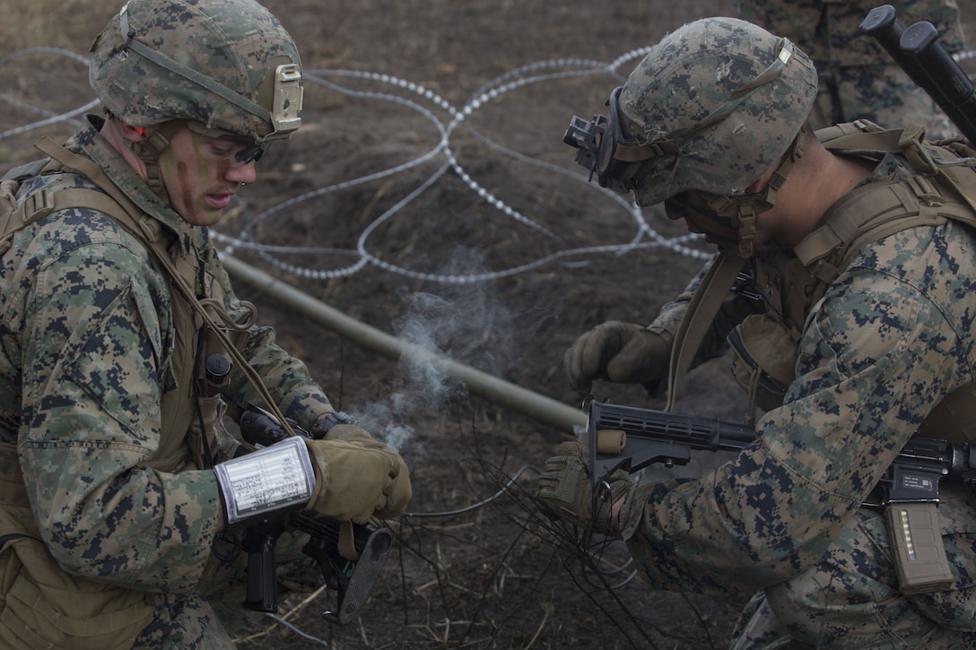 Marines with 2nd Battalion, 8th Marine Regiment activate the blasting caps for a Bangalore torpedo at a platoon live-fire range during a deployment for training exercise at Fort A.P. Hill, Va., Dec. 7, 2017. The Marines are conducting the training to maintain proficiency at the squad, platoon, company, and battalion-level of warfighting in preparation for an upcoming deployment to Japan. The Marines patrolled, detonated Bangalore torpedoes to breach obstacles, threw M67 fragmentation grenades to clear trenches, and conducted live-fire movements to take an objective. (U.S. Marine Corps photo by Lance Cpl. Ashley McLaughlin)
