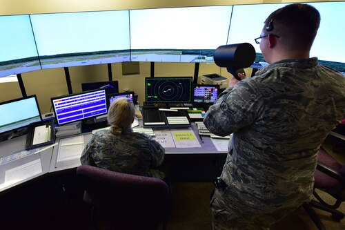 Senior Airman Gabriella Bellou, 19th Operations Support Squadron air traffic control journeyman, supervises Airman 1st Class Kyle Hood, 19th OSS air traffic control apprentice, as he uses a light gun to simulate signaling a plane which is unable to hear him over their normal lines of communication Jan. 11, 2018, at Little Rock Air Force Base, Ark. The light gun uses the colors: red, green and yellow to communicate with inbound aircraft. (U.S. Air Force photo by Airman 1st Class Rhett Isbell)