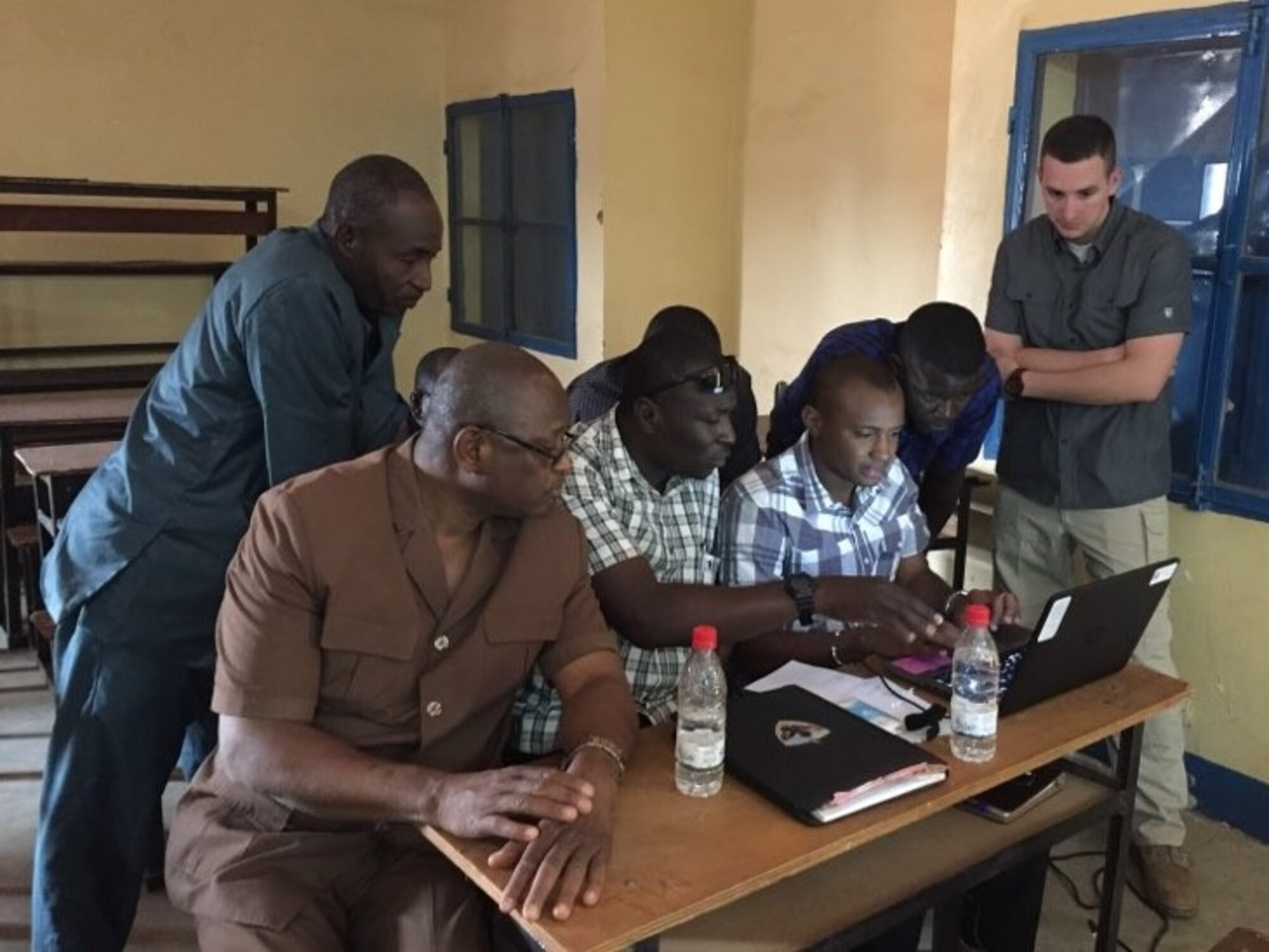 AFOSI SA Clayton Drown works with Nigerian counterparts to draft a real-world threat assessment in Niamey, during the inaugural DTAMS in Niger conducted by the AFOSI 25 EFIS Dec. 11-14 and 19-22, 2017. (Photo submitted by SA Helen Marino)